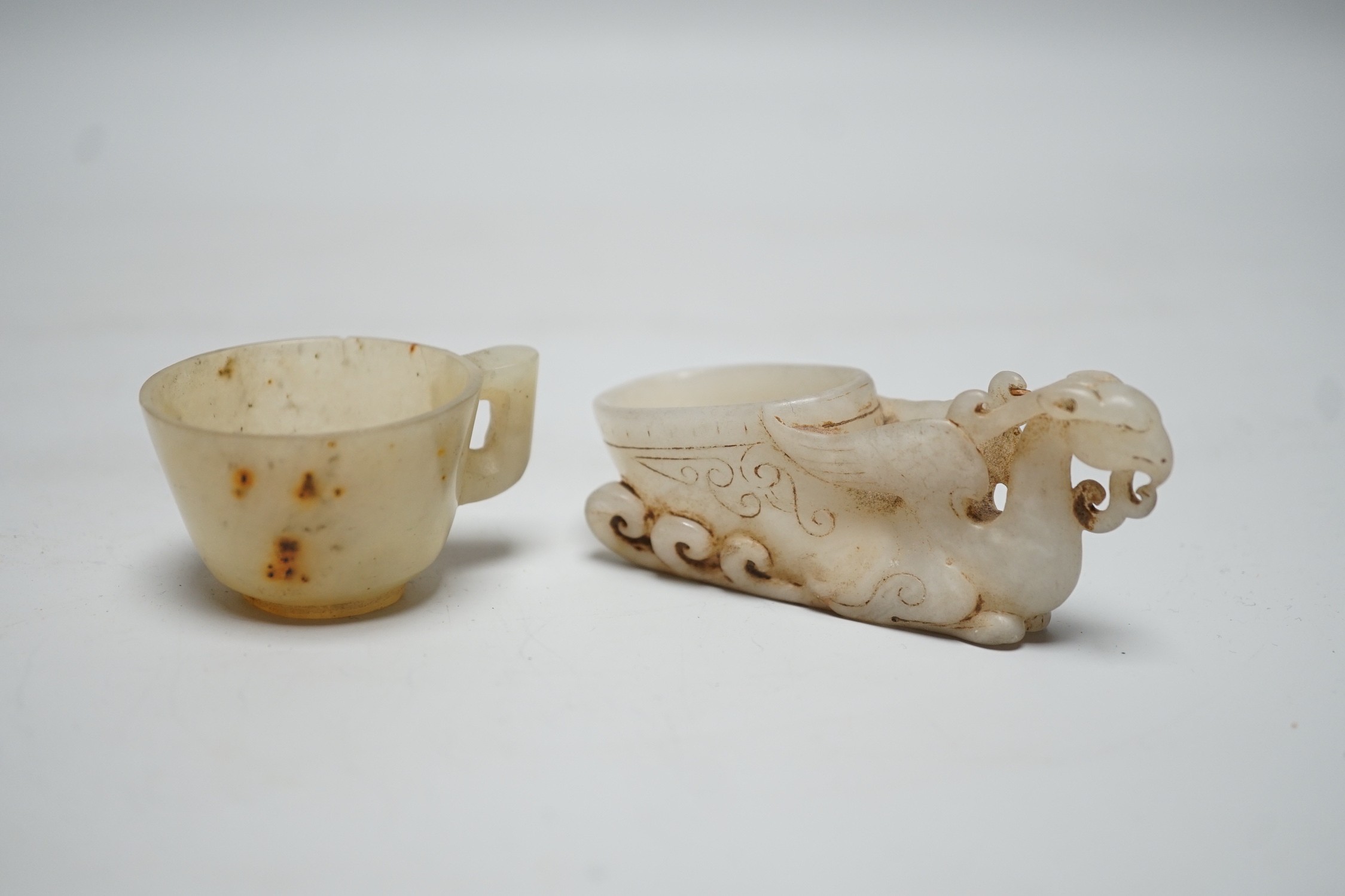 A Chinese hardstone rhyton cup and a bowenite jade cup, largest 9cm
